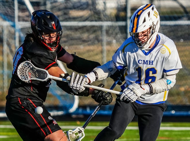 Cedarburg's Cameron Wallace, left battles for possession with Catholic Memorial's Randa Mikey (16) during the lacrosse match at Catholic Memorial on Wednesday, March 20, 2024.