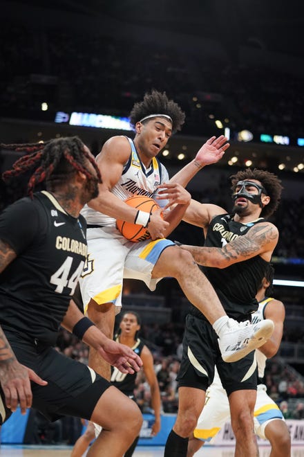 Mar 24, 2024; Indianapolis, IN, USA; Marquette Golden Eagles guard Stevie Mitchell (4) wins a rebound over Colorado Buffaloes guard J'Vonne Hadley (1) and center Eddie Lampkin Jr. (44) during the first half at Gainbridge FieldHouse. Mandatory Credit: Robert Goddin-USA TODAY Sports