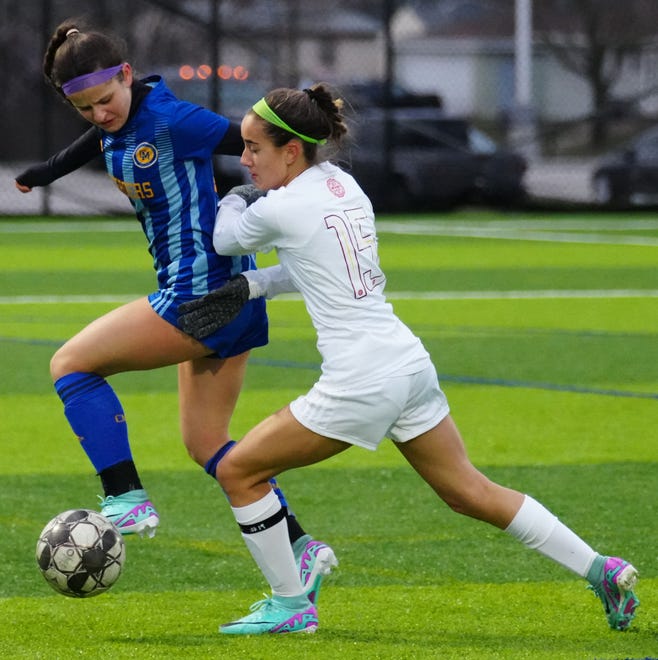 Catholic Memorial's Claire Weber, left, battles Divine Savior Holy Angels' Lily Filmanowicz (15) for possession during the match at Mindiola Park in Waukesha, Tuesday, March 26, 2024.