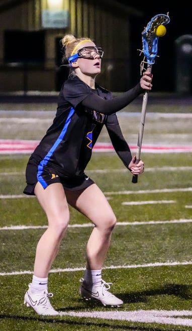 Mukwonago's Grace Byrnes (4) grabs a pass during the match at Arrowhead on Thursday, April 4, 2024.