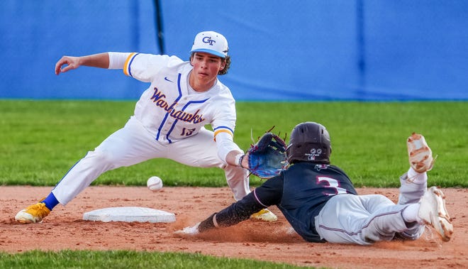 Germantown second baseman Colyn Lessila (13) catches Menomonee Falls' Henry Lynde (3) trying to steal during the game at Germantown, Friday, April 12, 2024.