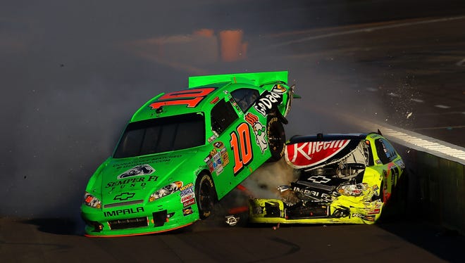 Danica Patrick (10) lands on top of Paul Menard during a crash on the final lap of the AdvoCare 500 at Phoenix International Raceway.