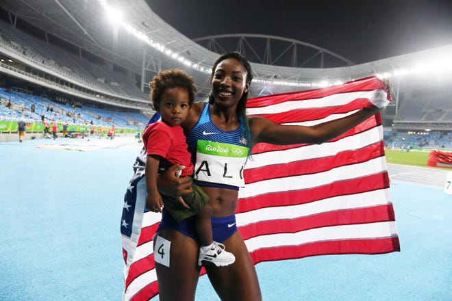 Nia Ali celebrates with her son Titus after placing second during the women's 100m hurdles final in the 2016 Rio Olympic. She also has a daughter Yuri.